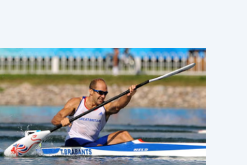 Sprint paddler with the airborne blade nearly flat to the wind